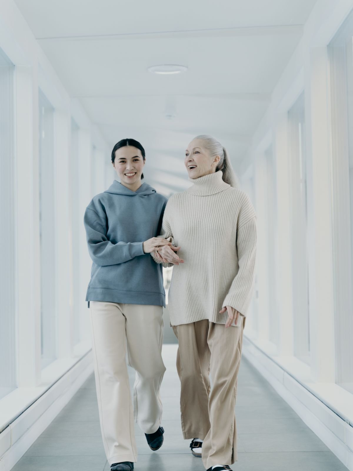 A caregiver gently supporting an elderly resident
